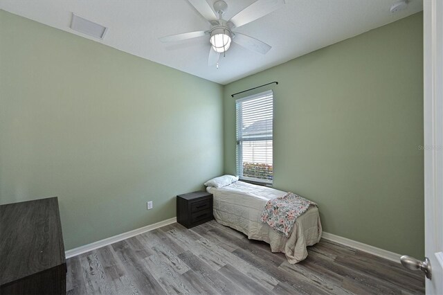 bedroom with ceiling fan and wood-type flooring