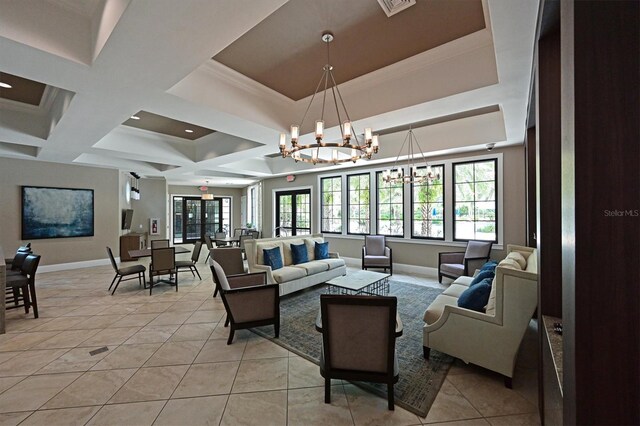 living room with plenty of natural light, light tile patterned flooring, a chandelier, and a raised ceiling