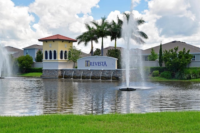 community sign featuring a water view