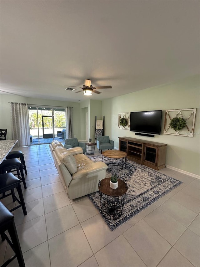 tiled living room featuring ceiling fan