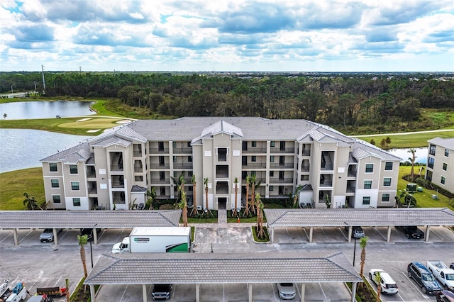 drone / aerial view with a water view and golf course view
