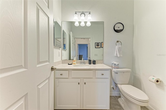 bathroom featuring vanity, toilet, and tile patterned floors