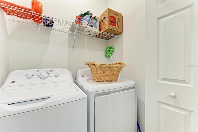 washroom with washing machine and clothes dryer