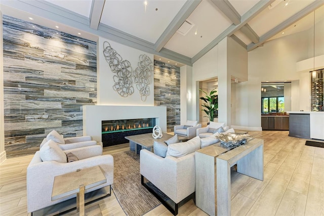 living room featuring high vaulted ceiling, light wood-type flooring, and beam ceiling