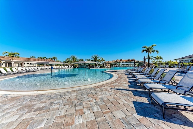 view of pool featuring pool water feature and a patio area