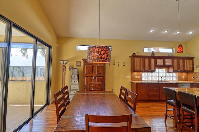 dining space featuring hardwood / wood-style flooring, plenty of natural light, and sink