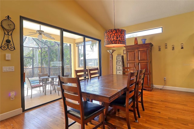 dining area featuring ceiling fan, light wood-type flooring, and lofted ceiling