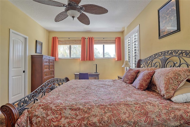 bedroom with a textured ceiling and ceiling fan