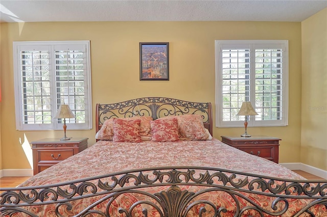 bedroom featuring a textured ceiling and hardwood / wood-style flooring