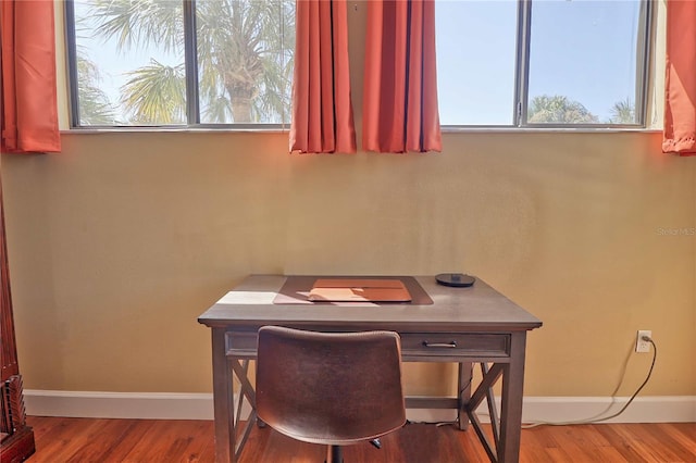 dining space with wood-type flooring