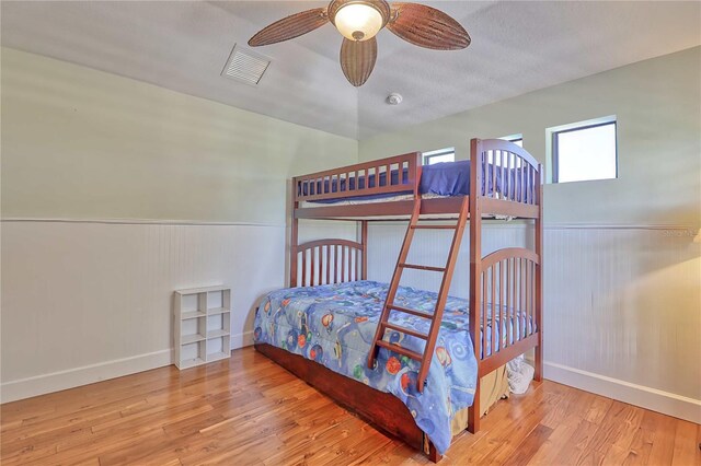 bedroom with vaulted ceiling, hardwood / wood-style floors, and ceiling fan