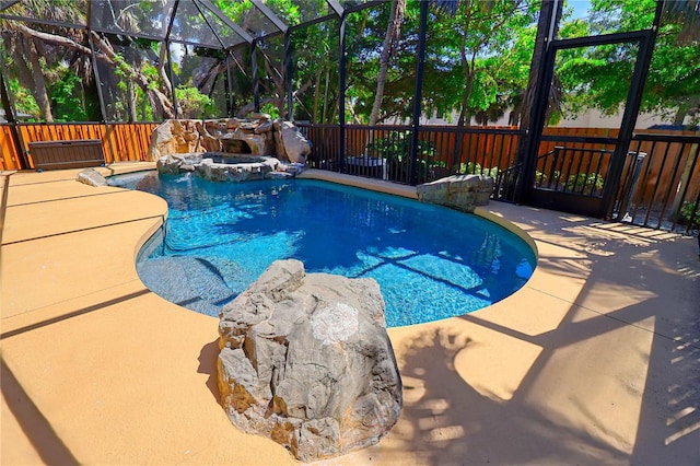 view of pool featuring a patio, an in ground hot tub, and a lanai