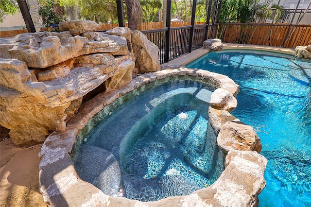 view of pool with an in ground hot tub