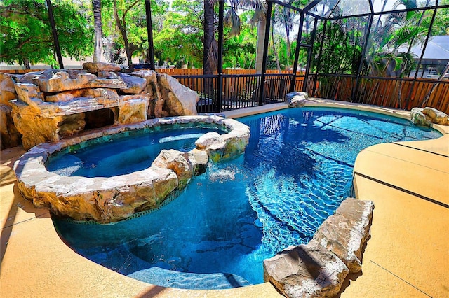 view of pool featuring a lanai and an in ground hot tub