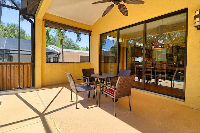 sunroom / solarium featuring ceiling fan