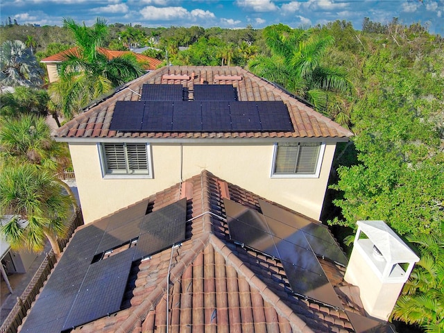 back of property featuring solar panels