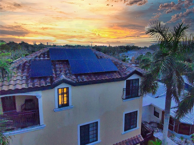 property exterior at dusk with solar panels