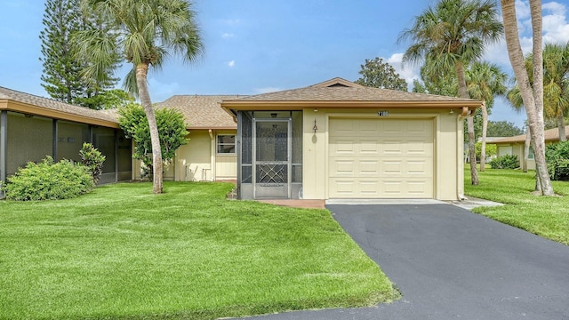 ranch-style house with a garage, a sunroom, and a front yard