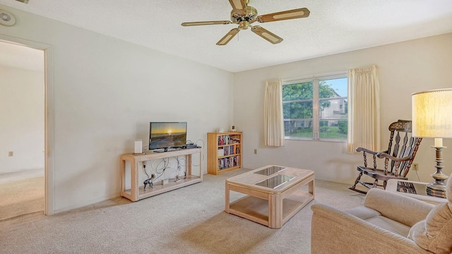 carpeted living room featuring a textured ceiling and ceiling fan