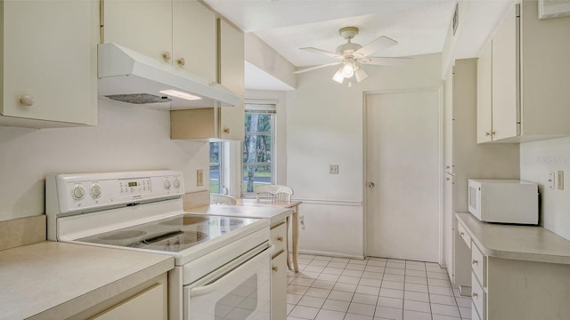 kitchen featuring white appliances, ceiling fan, light tile patterned floors, and cream cabinetry