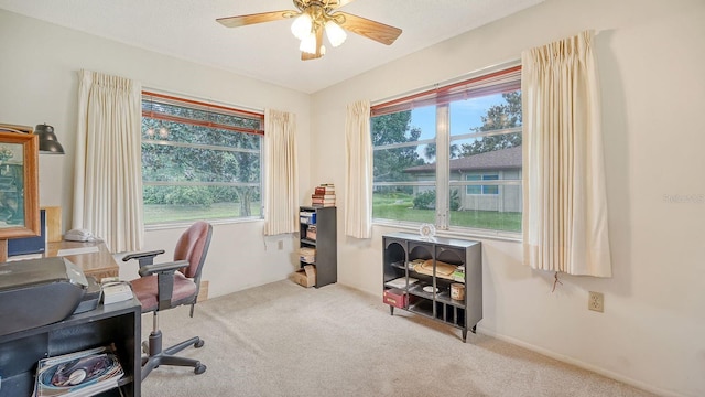 home office featuring ceiling fan and light carpet