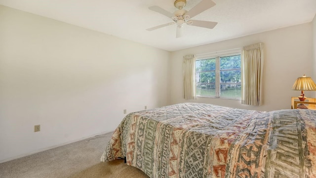 bedroom with light carpet and ceiling fan