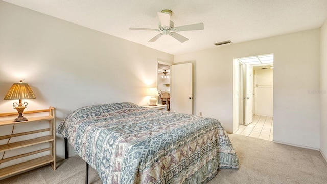 carpeted bedroom with ceiling fan and a textured ceiling