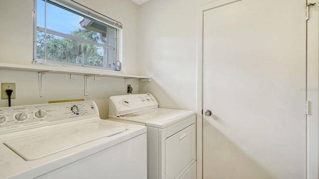 clothes washing area featuring independent washer and dryer