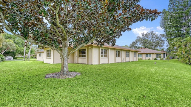 rear view of property featuring a yard