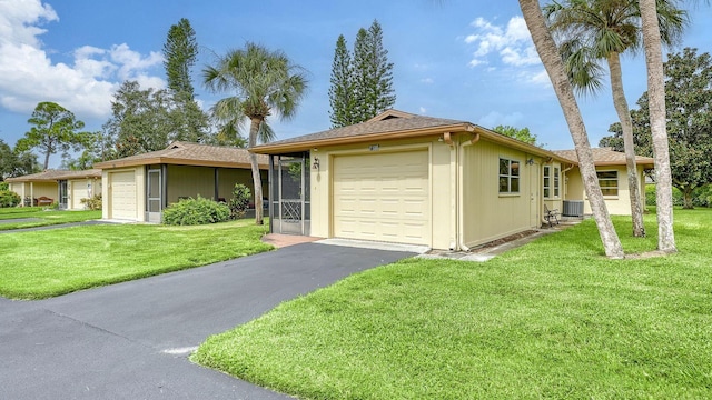 single story home with central AC unit, a garage, and a front lawn