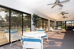 sunroom featuring ceiling fan