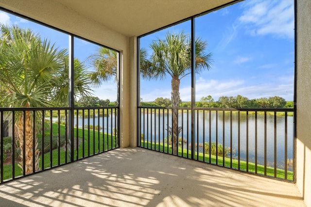 unfurnished sunroom with plenty of natural light and a water view