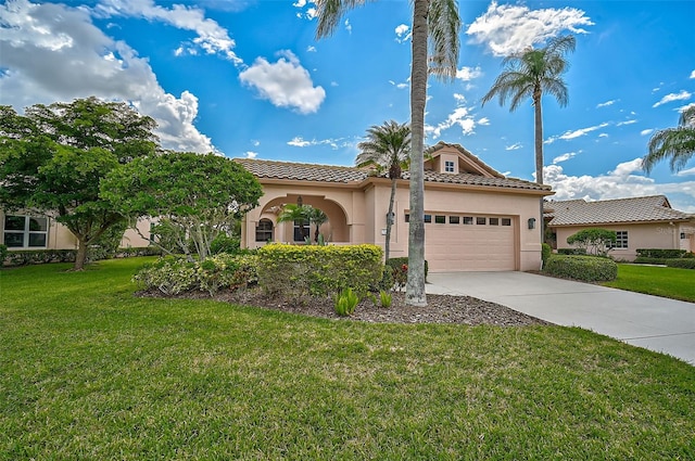 mediterranean / spanish-style house with a garage and a front yard