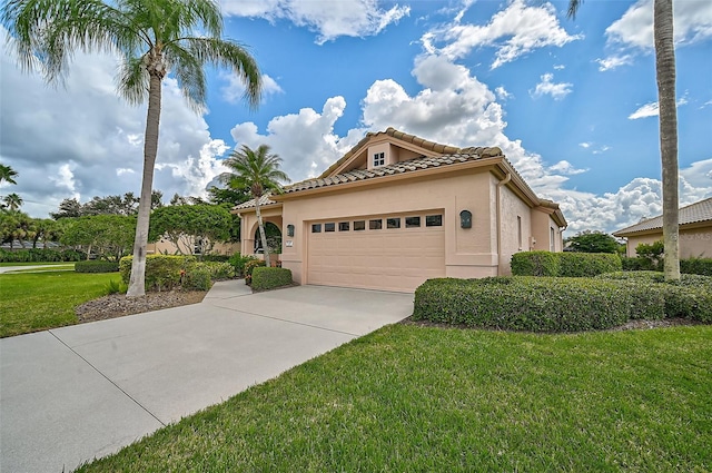 view of front of home with a front lawn and a garage