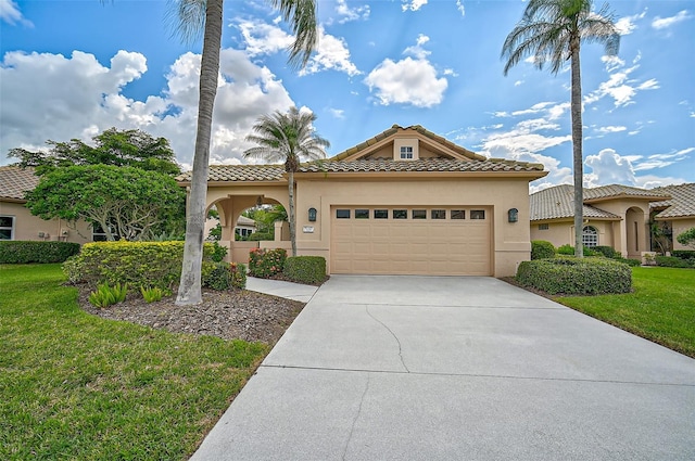 mediterranean / spanish-style home with a front yard and a garage