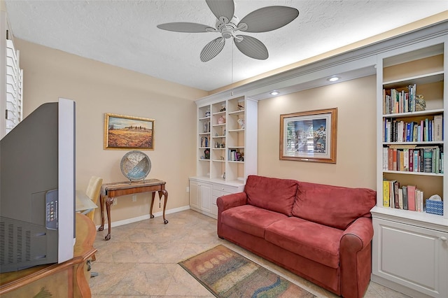 living room with a textured ceiling, ceiling fan, and built in features