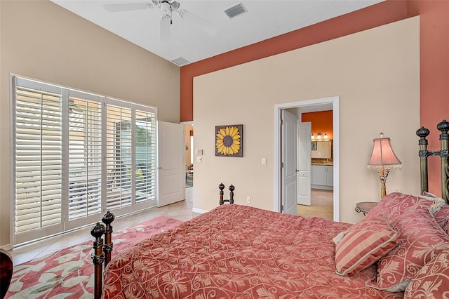 tiled bedroom featuring ensuite bath and ceiling fan