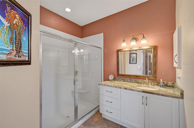 bathroom with vanity and a shower with door