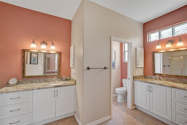 bathroom featuring vanity, toilet, tile patterned floors, and a shower with shower door