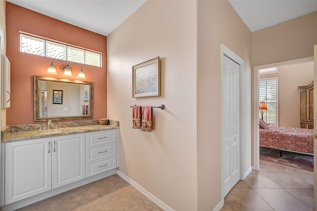 bathroom with vanity, tile patterned flooring, and a healthy amount of sunlight