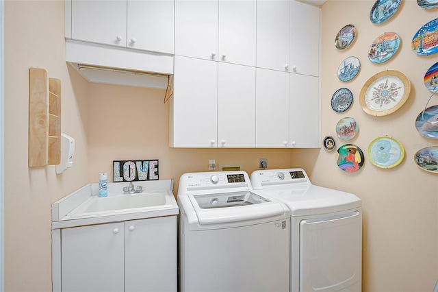 laundry room with sink, washer and dryer, and cabinets