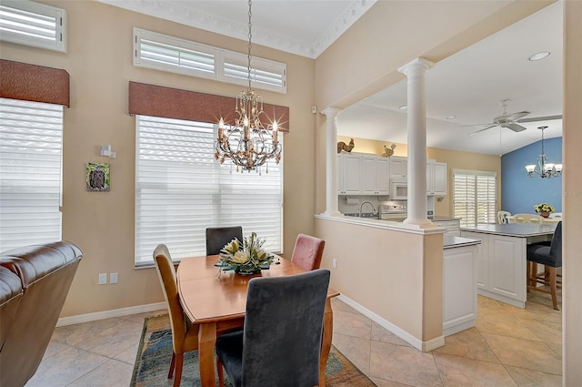 dining room featuring ceiling fan with notable chandelier, sink, light tile patterned floors, and ornate columns