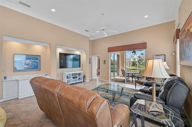 living room featuring ornamental molding, a high ceiling, ceiling fan, and light tile patterned floors