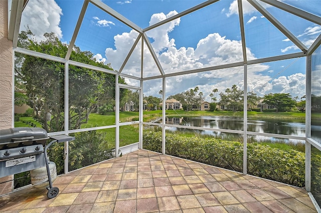 unfurnished sunroom with a water view