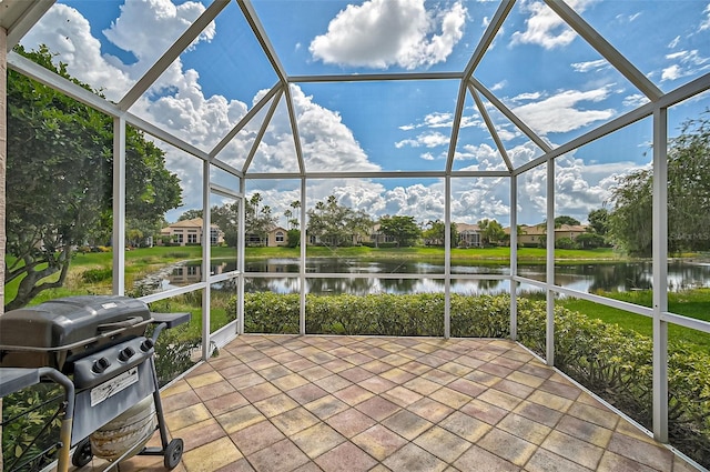 unfurnished sunroom with a water view