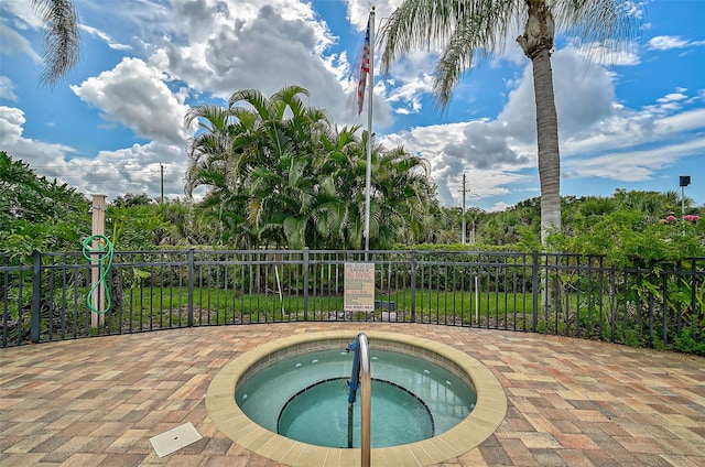 view of swimming pool with a community hot tub and a patio area