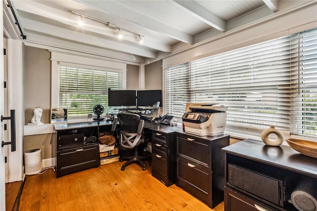 office area with light wood-type flooring and beamed ceiling