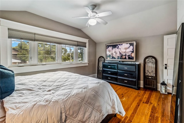 bedroom with lofted ceiling, dark hardwood / wood-style flooring, and ceiling fan