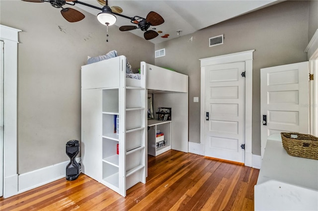 unfurnished bedroom with ceiling fan and dark hardwood / wood-style floors