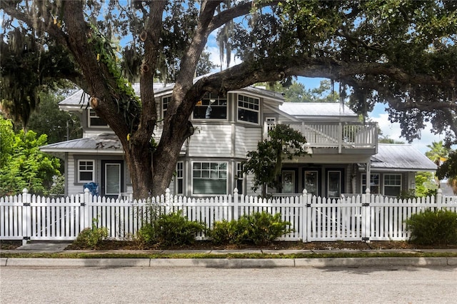 view of front of house featuring a balcony